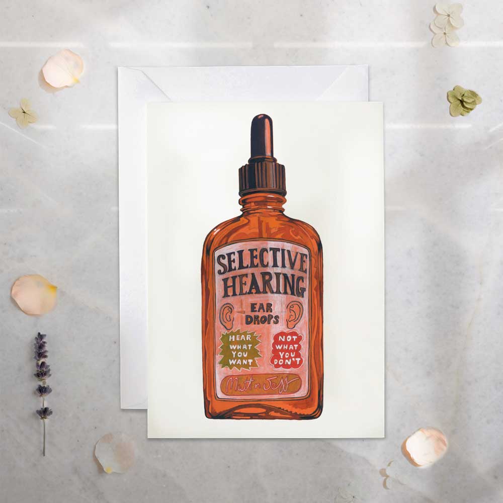 Vintage Bottle labeled 'Selective Hearing Ear Drops- hear what you want not what you don't' with a humorous label on a white background