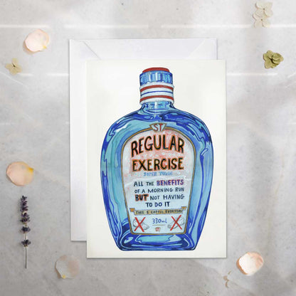 Greeting card with a blue bottle labeled 'Regular Exercise -All the benefits of a morning run but not having to do it' on a textured surface.