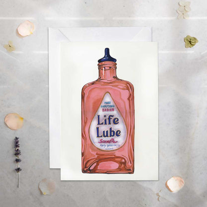Illustration of a Life Lube bottle on a textured surface with decorative elements.