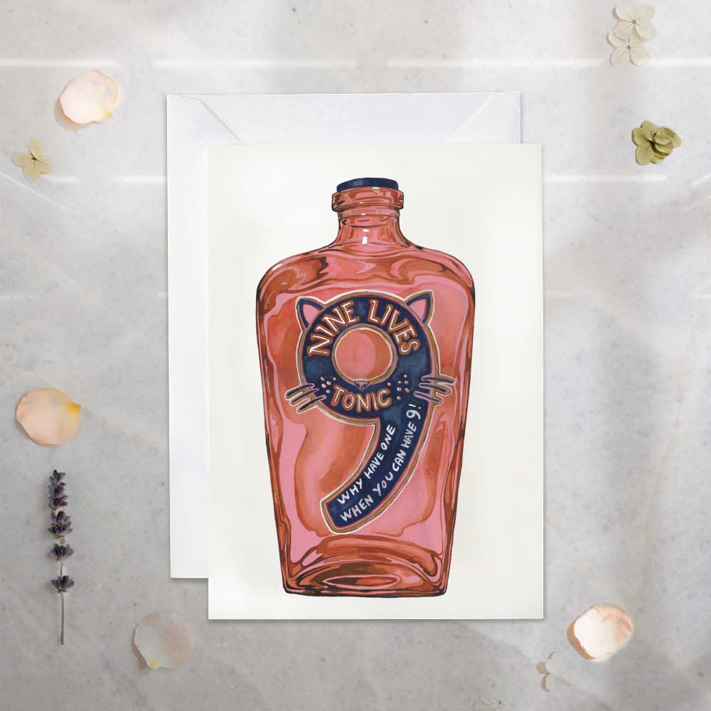 Pink bottle labeled 'Nine Lives Tonic' on a textured surface with decorative elements.