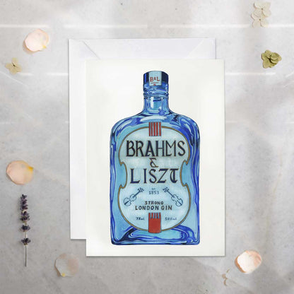 Brahms & Liszt gin bottle on a white card with decorative elements on a light gray background