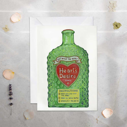 Greeting card 'Heart's Desire' potion get what you want! Green bottle design and 'Heart's Desire' text on a white background