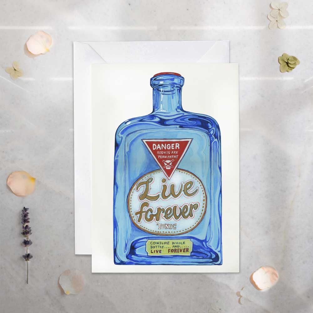 Greeting card- Live Forever Potion. Blue bottle design and 'Live Forever' text on a medical counter top